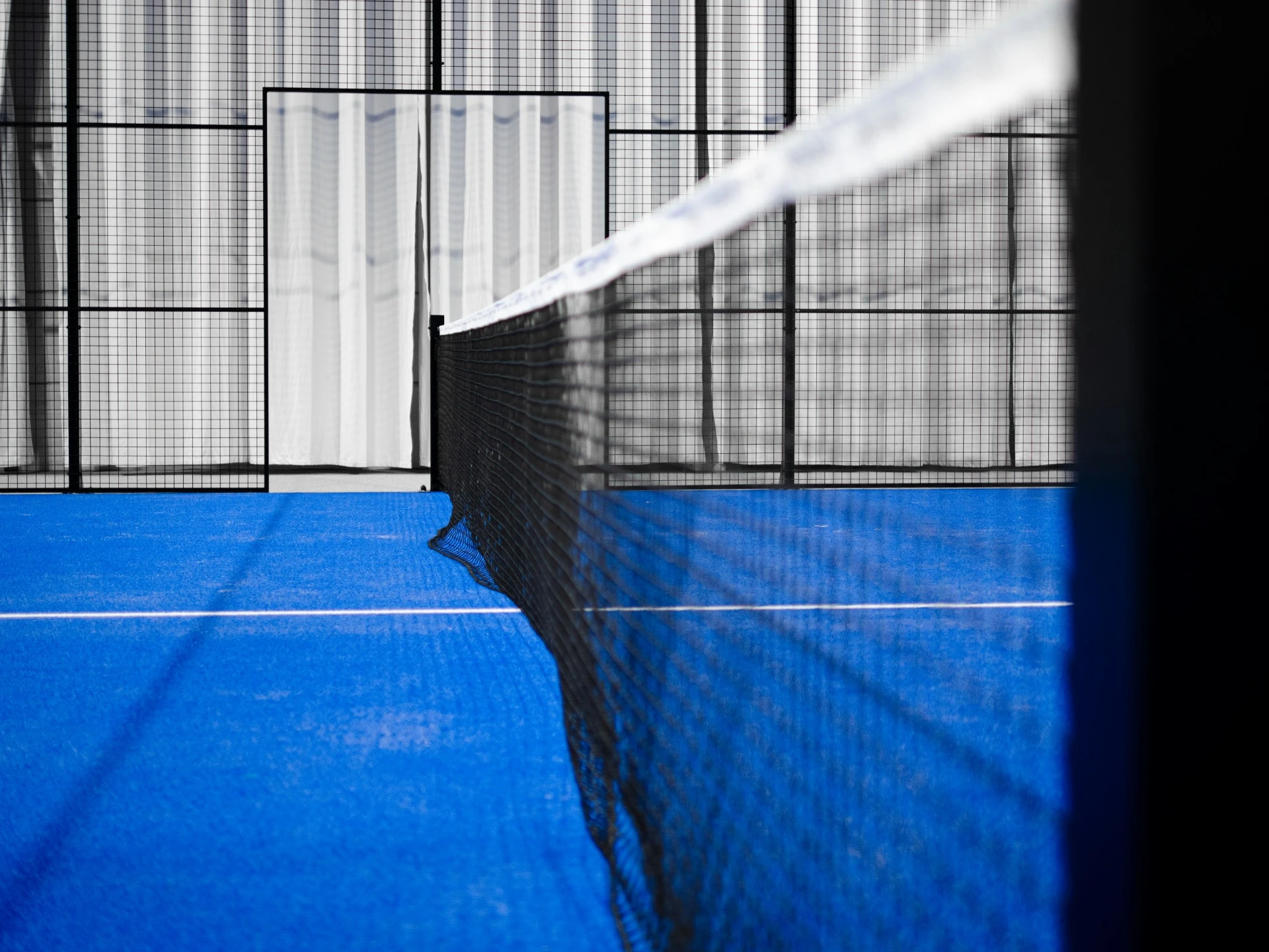 Padel court net inside an enclosed court